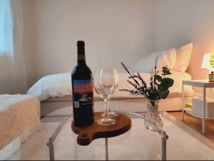 a bottle of wine and a wine glass on a table at 스테이일룸 in Sŭngch'ŏn-ni +21 photos