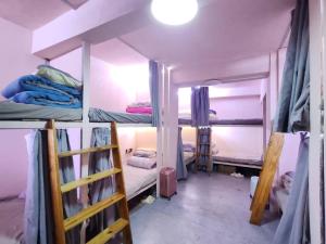 a room with three bunk beds in it at Green Hostel & Sunny Guesthouse in Yuanyang +25 photos
