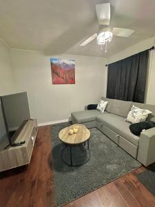 a living room with a couch and a table at Cozy Private Apartment with 2 Queen size Beds in Moncton