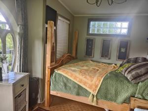 a bedroom with a bed and a window at garden cabin in Waikino