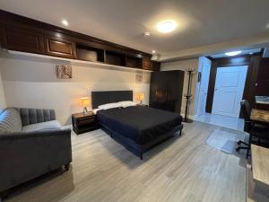 a bedroom with a bed and a couch at Spadina Boutique Rooms in Toronto