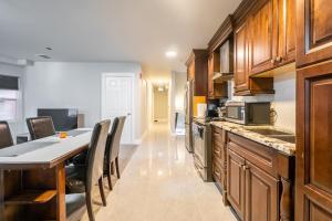 a kitchen with a table and a dining room at Spadina Boutique Rooms in Toronto