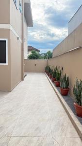 a patio with plants in pots on a building at Studio no centro de Pomerode! in Pomerode