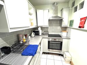 a kitchen with white cabinets and a blue towel on the counter at meze in Perth
