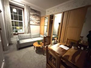 a living room with a couch and a table at meze in Perth