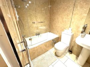 a bathroom with a toilet and a shower and a sink at meze in Perth