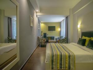 Postel nebo postele na pokoji v ubytování Cloud Hotel & Suites + 32 fotografií