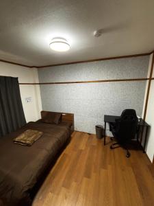 a bedroom with a bed and a desk with a chair at Stay Plus Azunoa in Oyama +47 photos