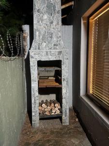 a stone fireplace with logs inside of it at 26 Rubens apartments in Secunda