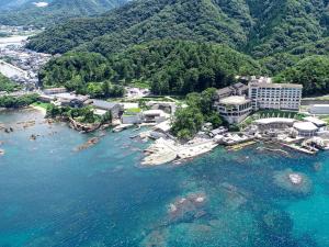 an aerial view of a resort on the water at Hotel Kinparo in Toyooka