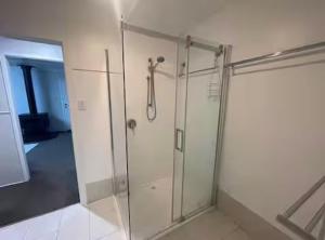 a shower with a glass door in a bathroom at Lahool Cottage in Stanthorpe +24 photos
