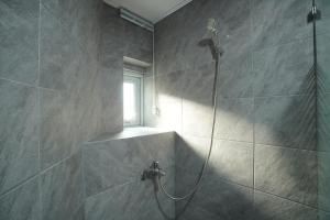 a bathroom with a shower with a window at NamSan203 Guest house in Seoul +43 photos