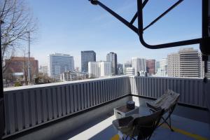 a balcony with a view of a city skyline at NamSan203 Guest house in Seoul