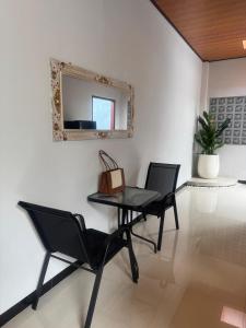 a table and chairs in a room with a mirror at Griya Becik Lovina - Private Pool Villa near Lovina Dolphin Spot in Lovina