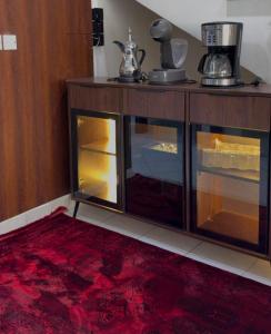 a wooden cabinet with glass doors and a red rug at فيلا بيتا خصوصيه في الشاطئ والمسبح in Durat Alarous