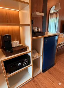 a kitchen with a stove and a refrigerator in a room at Simple Life Resort Koh Tao in Ko Tao