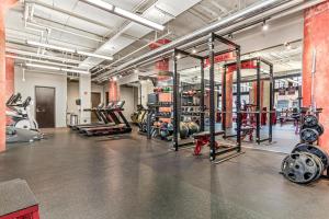 a gym with a lot of equipment in a room at 2KBD2BA Steps from Target Center+GYM+KTCHN+LNDRY in Minneapolis