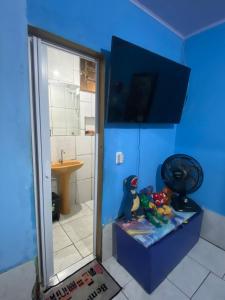 a bathroom with a sink and a shower with toys at flat temporada in Goiânia +3 photos