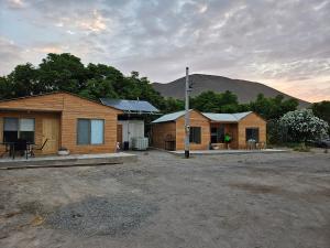 a group of houses with mountains in the background at Cabañas del cerro sombrero in Arica