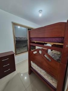 a bunk bed in a room with a window at Cabañas del cerro sombrero in Arica