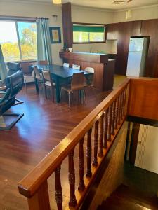 a dining room and kitchen with a table and chairs at Kite House in Guilderton