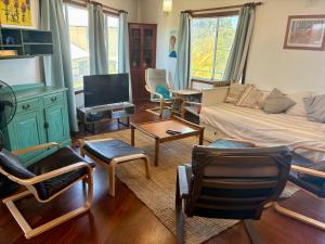 a living room with a couch and a tv at Kite House in Guilderton