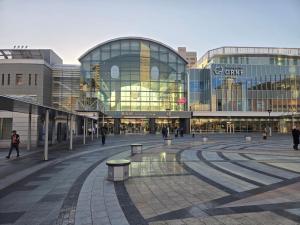 a large glass building with people walking around it at 旅館さくら in Takamatsu