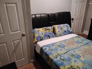 a bedroom with a bed with a black headboard at Grove#9 in Irvington +4 photos