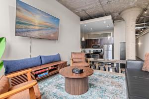a living room with a couch and a table at 2KBD2BA Steps from Target Center+GYM+KTCHN+LNDRY in Minneapolis