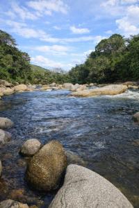 a river with some rocks in the water at Refugio La Tángara del Río in Cocorná