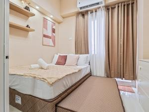 a small bedroom with a bed and a window at Mactan Cebu Cozy Relaxing Studio with Pool View Balcony in Pajak +10 photos