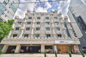 a large building with cars parked in front of it at Page 9 Hotel in Seoul