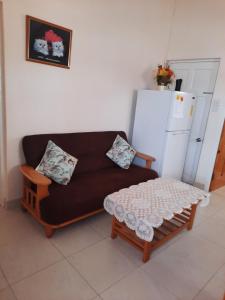 a living room with a couch and a table at Joyville in Bridgetown