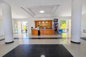 a lobby with a reception counter in a building at Bason Hotel Long Hải in Long Hai
