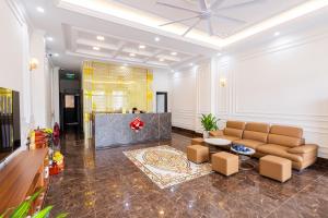 a living room with a couch and a table at Royal Louis Hotel in Hanoi