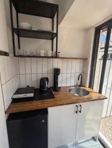 a kitchen with a sink and a counter top at Barefoot at Sunrise Guest Suite in Byron Bay