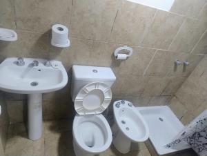 a bathroom with a toilet and a sink at Módulos ate 3 in Punta Alta