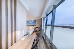 an apartment with a view of a bedroom at Atour Hotel Jining High-tech Zone in Jining