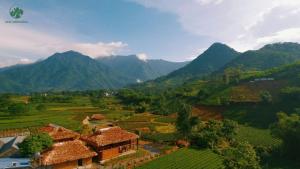 an aerial view of a village in a valley with mountains at Framstay Mây Sườn Đông in Ðại Từ