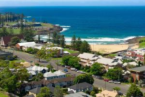 an aerial view of a town next to the ocean at Manning the Waves in Kiama