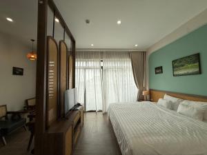 a bedroom with a bed and a flat screen tv at La May Boutique hotel in Ninh Binh +40 photos