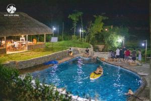 a group of people in a swimming pool at night at Framstay Mây Sườn Đông in Ðại Từ