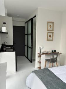 a bedroom with a bed and a table and a desk at Modern studio apartment Parque de la 93 in Bogotá
