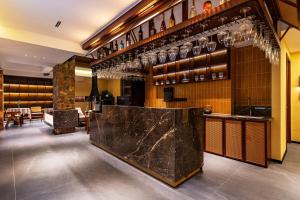 a bar in a restaurant with glasses on the wall at MiLO Hearth米罗设计民宿 张家界天门山索道店 in Zhangjiajie