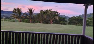 a view of a golf course with palm trees at The Golfing Shepherd in Mba