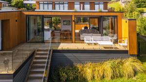 a house with glass doors and a patio at Renard Retreat in Akaroa