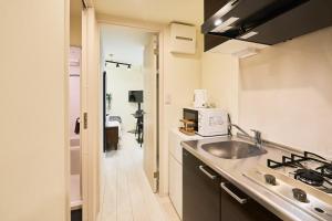 a small kitchen with a sink and a stove at Reberty Haneda in Tokyo +142 photos