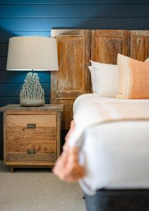 a bedroom with two beds and a table with a lamp at Jacaranda Noosa in Noosa Heads +212 photos