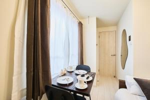 a living room with a table and a couch at Reberty Haneda in Tokyo