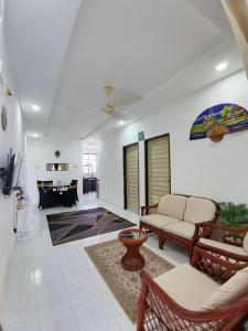 a living room with a couch and a table at 571 Seroja Homestay in Sungai Petani